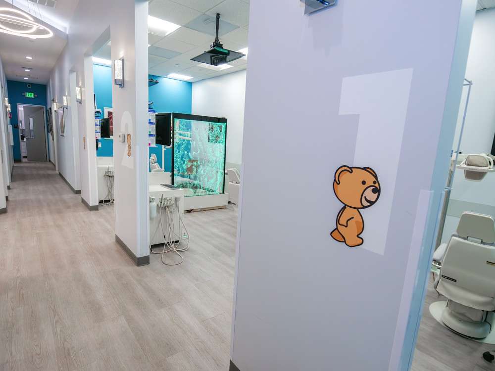 Hallway with bear-decal numbered treatment rooms